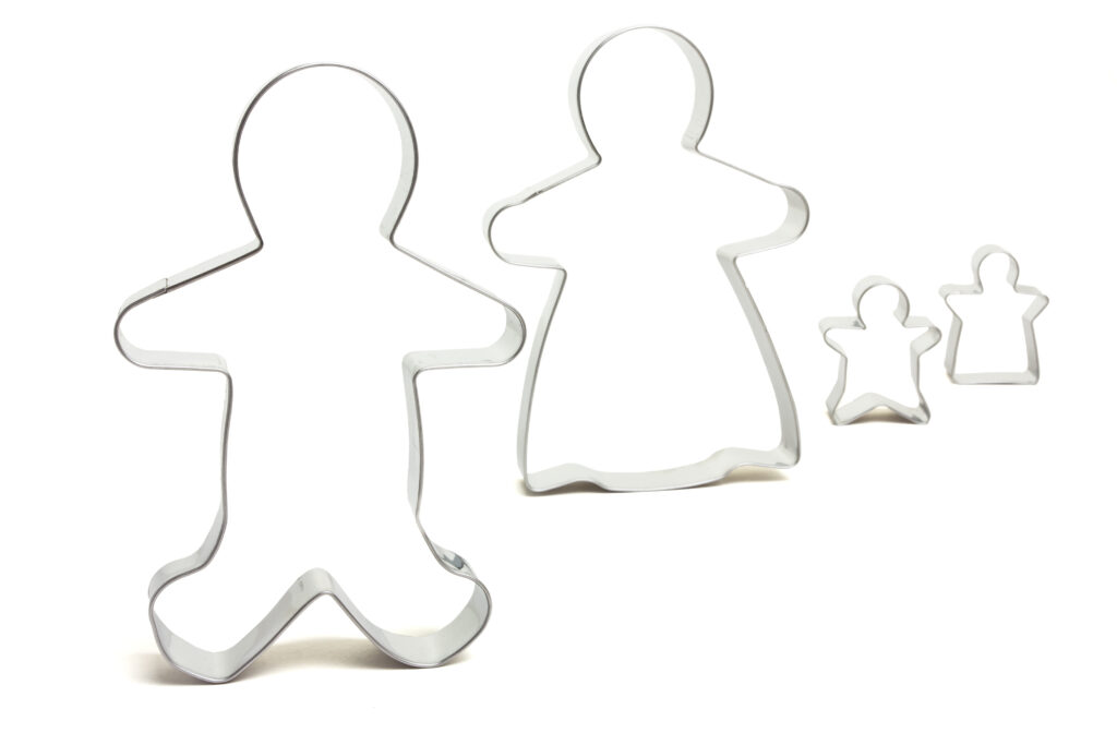 Family Unit Abstract concept of a set of cookie cutters isolated on white. I used this image to convey the concept of Anglo conformity in the United States.